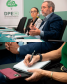 Imagem com duas fotos: acima, o desembargador Marcelo Semer e a defensora pública Gabriela Schirmer; abaixo, detalhe de participante da palestra escrevendo em caderno.
