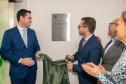Imagem horizontal colorida em que se vê o descerramento da placa do novo Posto de Atendimento da DPE-PR na Câmara Municipal de Curitiba. 