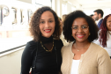 imagem de duas mulheres negras sorrindo durante o evento de lançamento do NUPIER