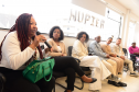 imagem com diversas pessoas representantes de coletivos negros sentados durante a roda de conversa com o NUPIER