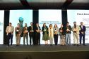 Imagem mostra os vencedores da Pesquisa Nacional de Transformação Digital e Gestão de Tecnologia nas Defensorias Públicas Estaduais posando no palco do Enastic, evento realizado em Foz do Iguaçu.