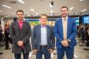 Três homens de terno posam para imagem durante o Mutirão. 