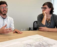 Equipe do NUFURB discute estratégias de atuação. Sobre a mesa se vê um mapa da comunidade. 