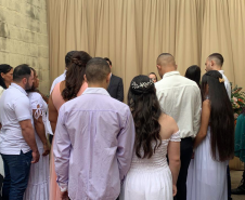 Imagem mostra de costas os 24 casais que se uniram em matrimônio na Cadeia Pública de Cornélio Procópio.