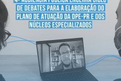 Duas pessoas assistem, em um notebook, um homem de barba e óculos em uma tela