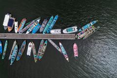 Imagem aérea mostra barcos vistos de cima no pier de Guaraqueçaba.