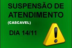 A imagem com fundo verde, possui os dizeres "Suspensão de Atendimento" , "Dia 14/11" destacados na cor preta e "(Cascavel)" na cor branca. 
Uma placa amarela com um sinal de exclamação está presente no lado direito inferior da imagem. 