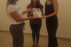 Na imagem vemos as Dras. Coordenadoras Eliana Tavares Paes Lopes e Cinthia Azevedo Santos e a presidente do Transgrupo Marcela Prado. Karollyne Nascimento segurando o documento “Diálogos Sobre Viver Trans - Monitoramento de Assassinatos e Violação de Direitos Humanos de Pessoas Trans no Brasil”.