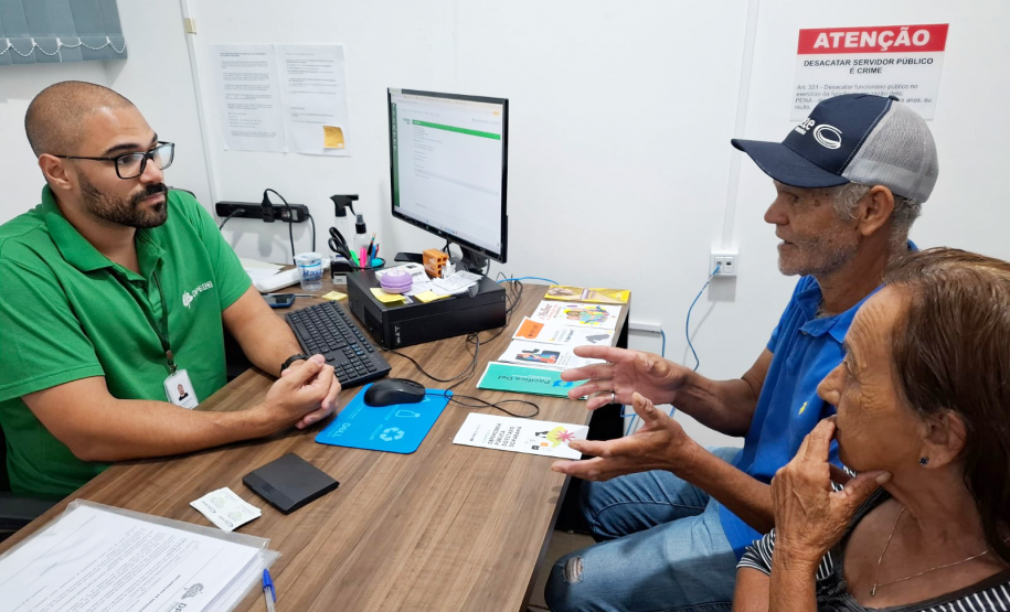 Servidor da DPE-PR atendendo casal de idosos durante mutirão do Concilia em Guaíra.